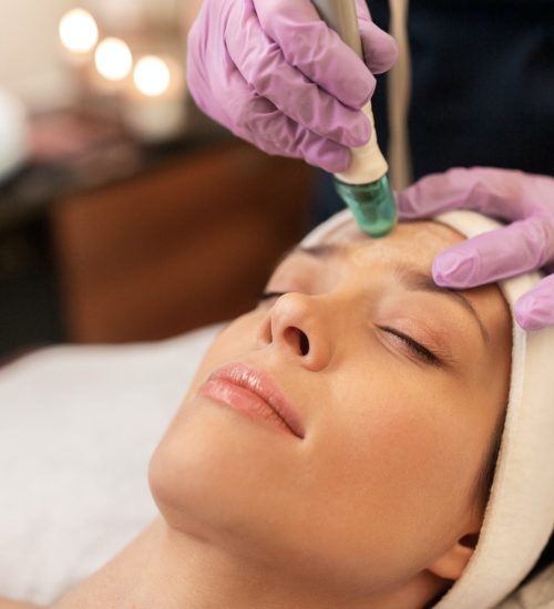 woman having microdermabrasion facial treatment
